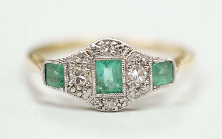 A 1920's 18ct & plat, millegrain set three stone emerald and four stone diamond ring, size R/S, gross weight 2.5 grams.